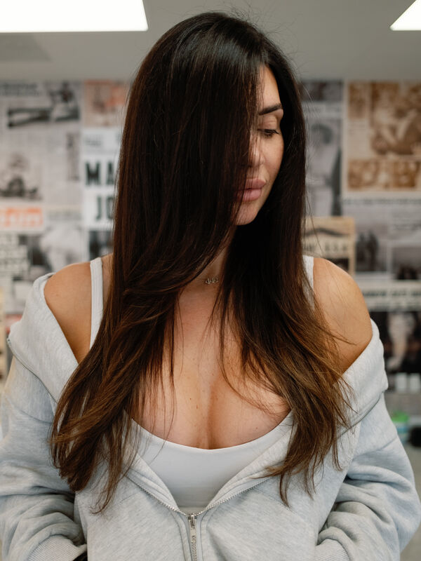 Long glossy brunette color by Vintage Roots Salon